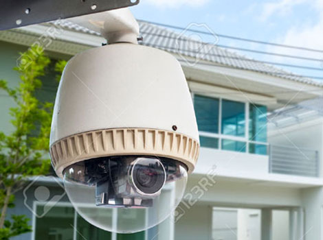 30380410-CCTV-Camera-or-surveillance-operating-with-house-village-in-background-Stock-Photo